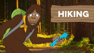 Steward Bigfoot in sunlit forest with "hiking" written on a cartoon wooden sign