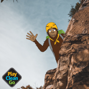 Steward bigfoot wearing helmet and climbing on red rocks