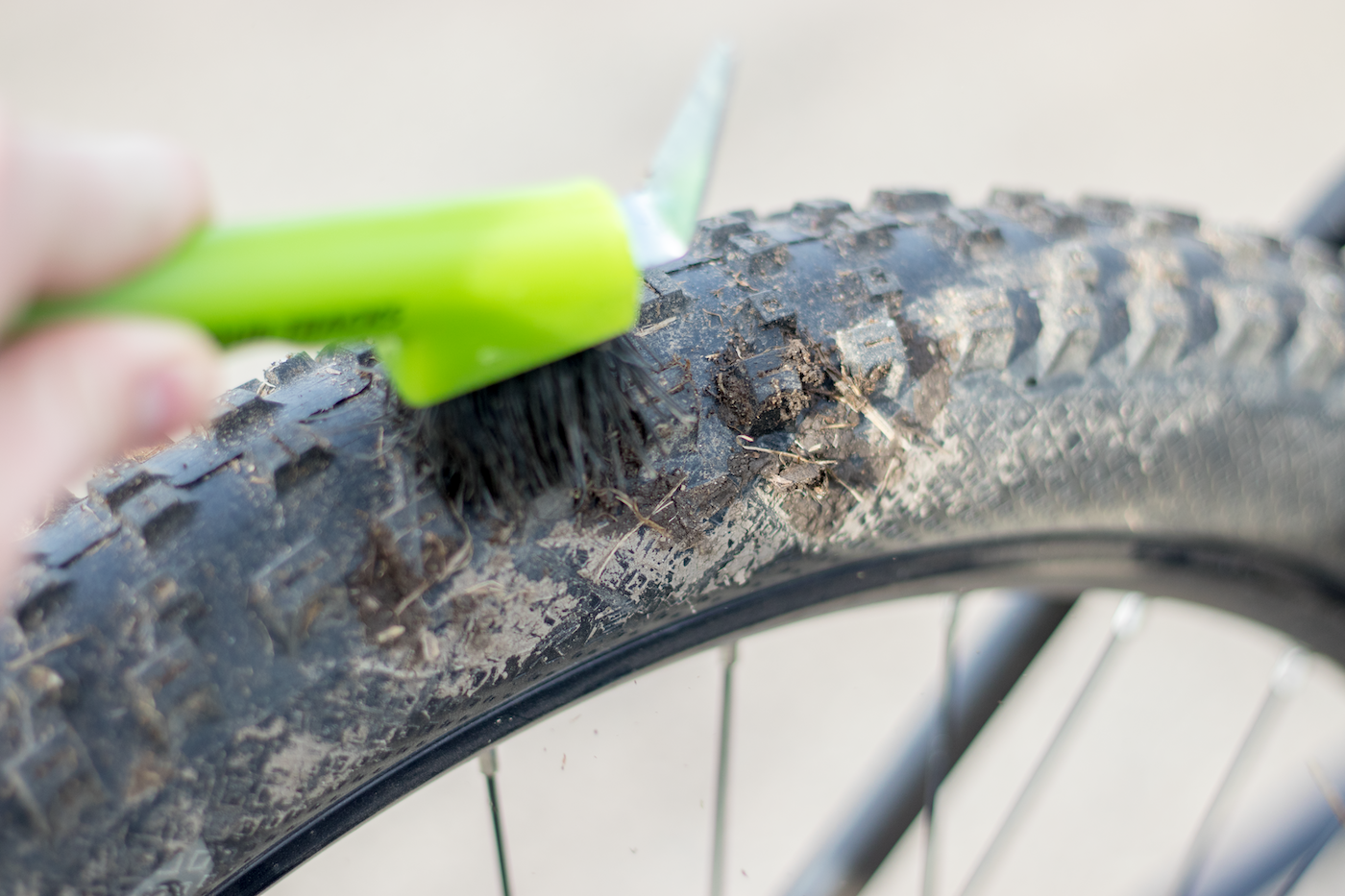 A brush removing mud from a mountain bike tire