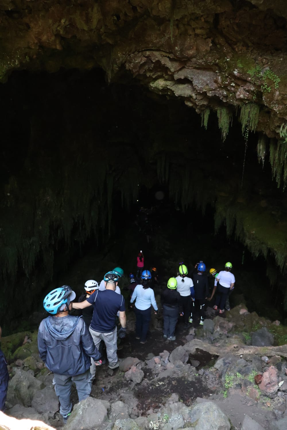 A group wearing helmets exploring a cave