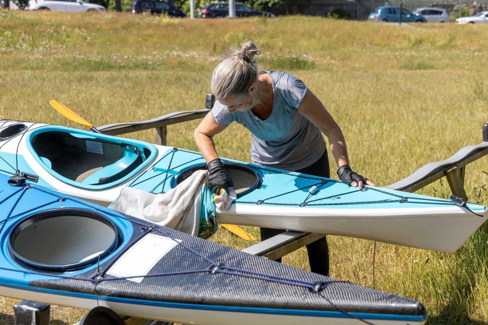 A paddler cleaning a kayak before an adventure